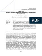 A critical review of seismic bearing capacity of foundation on sloping ground