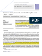 Dynamics of Rotating Thermoelastic Disks With Stationary Heat Source