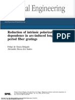 Reduction of Intrinsic Polarization Dependence in Arc-Induced Long-Period Fiber Gratings