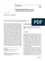 Response of Skirted Strip Footing Resting On Layered Granular Soil Using 2 D Plane Strain Finite Element Modeling